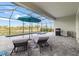 Outdoor screened-in pool and spa area with lounge chairs and a grill, perfect for entertaining at 11088 Pinot Dr, Venice, FL 34293