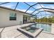 Exterior view of a screened pool and spa with a covered patio, perfect for outdoor relaxation at 11088 Pinot Dr, Venice, FL 34293