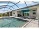 Screened pool and spa area with outdoor seating, grill and beautiful view of neighborhood and sky at 11088 Pinot Dr, Venice, FL 34293
