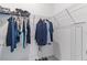 Walk-in closet with adjustable shelving and hanging rods, perfect for organizing clothes and accessories at 11088 Pinot Dr, Venice, FL 34293