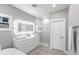 Bright bathroom with double vanity, LED mirror, and glass-enclosed shower at 14130 Massey Ave, Port Charlotte, FL 33953