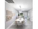 Bright dining room with contemporary lighting and seating for six at 14174 Packard Ave, Port Charlotte, FL 33953