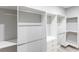 Large walk-in closet featuring custom shelving and a sleek, modern design at 14174 Packard Ave, Port Charlotte, FL 33953
