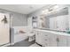 A clean bathroom featuring a soaking tub, glass shower, tiled floor, and double sink vanity at 1444 Frisco Ter, Port Charlotte, FL 33953