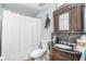 Chic bathroom features a dark wood vanity with granite countertop and tiled backsplash at 1444 Frisco Ter, Port Charlotte, FL 33953