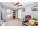 A spare bedroom featuring a ceiling fan, a window overlooking a green landscape, and neutral carpet at 1444 Frisco Ter, Port Charlotte, FL 33953