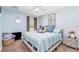 Bedroom with a large window, neutral carpet, queen bed, and soft blue walls at 1444 Frisco Ter, Port Charlotte, FL 33953