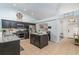 Well-lit kitchen with granite countertops, tiled floors, stainless steel appliances, and an island at 1444 Frisco Ter, Port Charlotte, FL 33953
