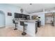 Spacious kitchen featuring dark cabinets, granite countertops, and a convenient breakfast bar for casual dining at 1444 Frisco Ter, Port Charlotte, FL 33953