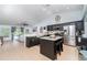 Bright kitchen featuring dark cabinets, granite countertops, stainless steel appliances, and an island with seating at 1444 Frisco Ter, Port Charlotte, FL 33953