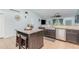 Well-equipped kitchen featuring a center island with bar stools, stainless steel appliances, and granite countertops at 1444 Frisco Ter, Port Charlotte, FL 33953
