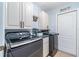 Laundry room featuring modern washer and dryer and white cabinets at 1444 Frisco Ter, Port Charlotte, FL 33953