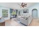 Cozy living room with tile floors, a ceiling fan, and sliding glass doors that lead to an outdoor pool at 1444 Frisco Ter, Port Charlotte, FL 33953