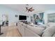 Comfortable living room featuring tile floors, a ceiling fan, and views of the outdoor pool at 1444 Frisco Ter, Port Charlotte, FL 33953