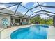 Backyard with screened in in-ground pool, spa, covered patio and a beautifully landscaped backyard at 1444 Frisco Ter, Port Charlotte, FL 33953