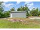 Exterior view of metal storage shed on a grassy lot at 1444 Frisco Ter, Port Charlotte, FL 33953