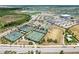 Aerial view of community amenities including tennis courts, pickleball courts, a sports field and parking at 15069 Anchorage Rd, Punta Gorda, FL 33982