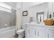 Well-lit bathroom with a tub and shower combo and white cabinets at 15069 Anchorage Rd, Punta Gorda, FL 33982