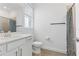 Well-lit bathroom featuring tile floors, a single vanity with a mirror, and a shower-tub combination at 15069 Anchorage Rd, Punta Gorda, FL 33982