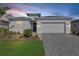 Charming home with a neatly landscaped front yard and a paver driveway leading to a two-car garage at 15069 Anchorage Rd, Punta Gorda, FL 33982