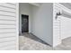 A beautifully decorated front door welcomes you to this home, complemented by stylish exterior lighting at 15069 Anchorage Rd, Punta Gorda, FL 33982