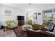 Cozy living room with plush seating, a large window overlooking a lake, and stylish decor at 15069 Anchorage Rd, Punta Gorda, FL 33982