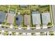 An aerial view of well-maintained homes shows manicured lawns, driveways, and swimming pools in a modern neighborhood at 16176 Lotus Way, Punta Gorda, FL 33982