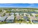 Aerial view of a residential community showcasing houses, a lake, and lush surroundings at 16176 Lotus Way, Punta Gorda, FL 33982