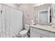 Neutral bathroom with a single sink vanity, granite countertops, and a shower-tub combination with a white curtain at 16176 Lotus Way, Punta Gorda, FL 33982
