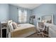 A well-lit bedroom featuring light blue walls, white trim, and soft furnishings at 16176 Lotus Way, Punta Gorda, FL 33982