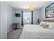 Comfortable bedroom with soft blue walls and ample light from the large window at 16176 Lotus Way, Punta Gorda, FL 33982