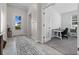 Bright hallway with decorative rug and view to office space at 16176 Lotus Way, Punta Gorda, FL 33982