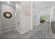 Bright hallway with decorative rug, accent wall decor and views to other rooms at 16176 Lotus Way, Punta Gorda, FL 33982