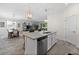 Open concept kitchen with granite island, stainless steel dishwasher, and open view to the living and dining areas at 16176 Lotus Way, Punta Gorda, FL 33982