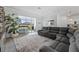 Inviting living area with access to a screened patio, featuring a comfortable sectional sofa and neutral decor at 16176 Lotus Way, Punta Gorda, FL 33982