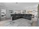 Open-concept living area flowing from the kitchen to the living room, featuring a large sectional sofa at 16176 Lotus Way, Punta Gorda, FL 33982