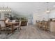 Open-concept living area featuring modern lighting, wood-look tile floors, and a seamless flow to the kitchen at 16176 Lotus Way, Punta Gorda, FL 33982