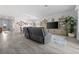 Spacious living room featuring a large gray sofa, decorative shelving, and a stylish rug at 16176 Lotus Way, Punta Gorda, FL 33982