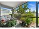 Relaxing screened-in patio featuring comfortable seating and views of the manicured backyard at 16176 Lotus Way, Punta Gorda, FL 33982