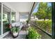 Relaxing screened-in patio featuring comfortable seating and views of the manicured backyard at 16176 Lotus Way, Punta Gorda, FL 33982