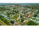 Aerial view of a residential neighborhood highlighting a home with mature landscaping, and waterway access at 1721 Walden Ct, Englewood, FL 34224