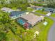 Aerial view of a home with a screened-in pool, set within a well-maintained neighborhood at 1721 Walden Ct, Englewood, FL 34224