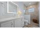 This bright bathroom features a quartz vanity, tile shower, and wood-look tile flooring at 1721 Walden Ct, Englewood, FL 34224