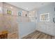Modern bathroom features a glass-enclosed shower with tile walls and a vanity with an illuminated mirror at 1721 Walden Ct, Englewood, FL 34224