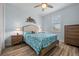 This bedroom features a comfortable bed, wood-look flooring, and a bright window at 1721 Walden Ct, Englewood, FL 34224