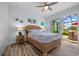 This stylish bedroom features a wicker bed frame, coastal decor, and access to the outdoor patio at 1721 Walden Ct, Englewood, FL 34224