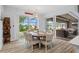 Dining area with a round table, six chairs, and sliding glass doors leading to a screened-in pool area at 1721 Walden Ct, Englewood, FL 34224