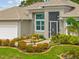 Charming single-story home with well-manicured landscaping, a seating area, and a decorative front door at 1721 Walden Ct, Englewood, FL 34224