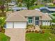 Charming single-Gathering home featuring a well-maintained lawn, a two-car garage, and a quaint outdoor seating area at 1721 Walden Ct, Englewood, FL 34224