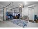 Spacious two-car garage setup with a pinball machine, work area, and ample room for parking at 1721 Walden Ct, Englewood, FL 34224